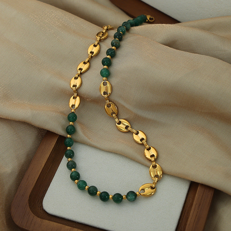 Close up of Emerald Bead Gold Necklace