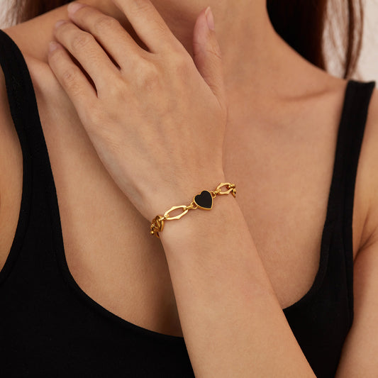 Woman Wearing Black Heart Charm Figaro Bracelet